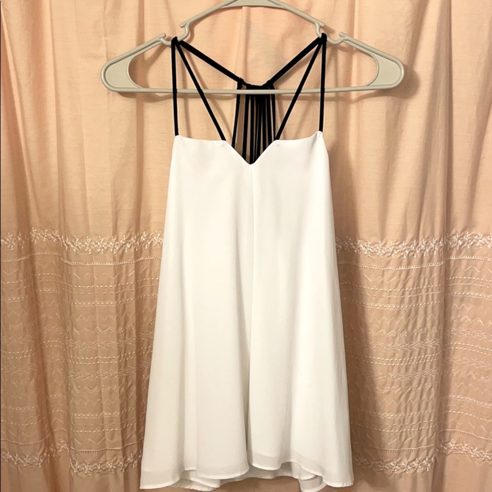 Elegant white tank top with detailed black straps!